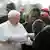 African clergyman kissing Pope Benedikt's hand