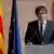 Catalan President Carles Puigdemont speaks in front of flags