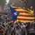 People wave "estelada" or pro independence flags in Barcelona, Spain, after Catalonia's regional parliament passed a motion with which they say they are establishing an independent Catalan Republic,