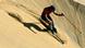 A man skis down the side of a sand dune in Namibia A man skis down the side of a sand dune in Namibia
