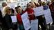 Women hold placards at a sexual violence protest in France Women hold placards at a sexual violence protest in France