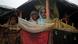 Rohingya women look out of a shelter in a refugee camp Rohingya women look out of a shelter in a refugee camp