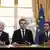 French President Emmnauel Macron, center, addresses the medias with French Interior Minister Gerard Collomb, left, and government spokesman Christophe Castaner after signing a counterterrorism law