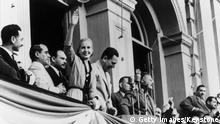 24th October 1949: Eva Duarte De Peron (1919 - 1952) waving to the crowds on the occasion of the 4th anniversary of her husband's government. Her husband, President Juan Domingo Peron (1895 - 1974) is on her left. (Photo by Keystone/Getty Images)