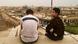 Two young men sit on a tall building looking out over Erbil, the capital of Iraqi Kurdistan. One man is wearing a T-shirt that says "sovereign state" in English. Two young men sit on a tall building looking out over Erbil, the capital of Iraqi Kurdistan. One man is wearing a T-shirt that says "sovereign state" in English.