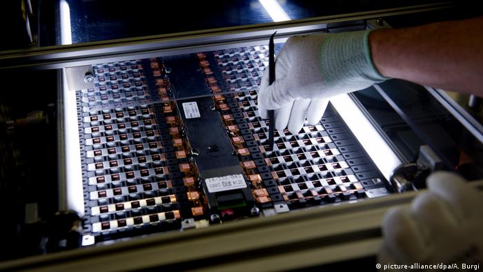 Worker testing lithium ion battery at Daimler subsidiary ACCUmotive