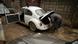 An old VW Beetle being refutbished by an African mechanic An old VW Beetle being refutbished by an African mechanic