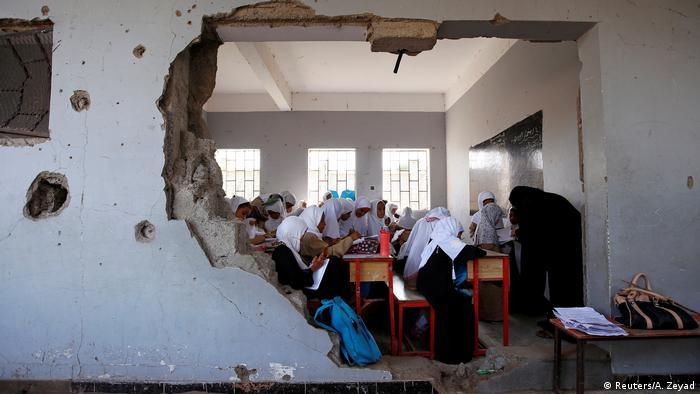 Girls attend a class at their school, which was damaged by a recent Saudi-led airstrike