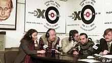TV6 director Yevgeny Kiselyov, right, and his colleagues speak on Ekho Moskvy radio Moscow, Monday, Jan. 21, 2002, with a portrait of Russian President Vladimir Putin, a part of a new 2002 calendar, The 12 moods of Putin, at left . Shown from right are: Kiselyov, Viktor Shenderovich, Andrei Norkin, Andrei Cherkizov, Yelena Kurlyantseva. Kiselyov rejected Monday an earlier compromise deal with the government to stay on the air, and court bailiffs urged the Media Ministry to yank its license. (AP Photo/ Mikhail Metzel)