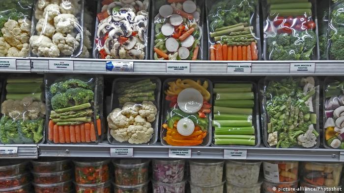 Shelves of chopped vegetables in plastic trays