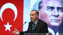 Backdropped by a poster of Mustafa Kemal Ataturk, Turkey's President Recep Tayyip Erdogan, delivers a speech in Konya, central Turkey, Saturday, Oct. 28, 2017. (Kayhan Ozer/Pool Photo via AP) |