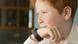Boy speaking into smartwatch Boy speaking into smartwatch