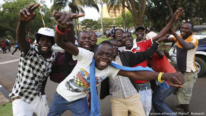 Zimbabweans celebrate the end of Mugabe's 37-year rule on the streets of the capital, Harare