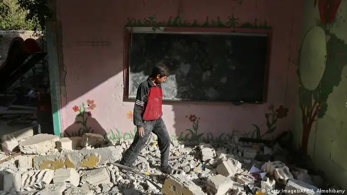 Boy walking on rubble in the town of Hamouria, near Damascus (Getty Images/AFP/A. Almohibany)