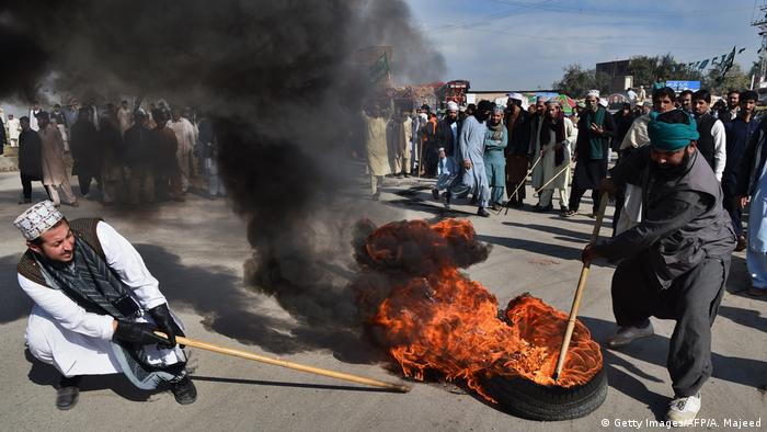 Protesters burn tires during a protest in Peshawar on November 25, 2017.