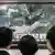 South Koreans watching a TV news program on the North Korean rocket launch at a train station in Seoul on April 5, 2009.