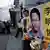 People demonstrate in Hong Kong with photos of the Taiwanese human rights activist Lee Ming-che