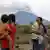 Bali women and children observe the volcanic eruption