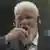 Praljak drinking from a glass bottle in the Hague courtroom