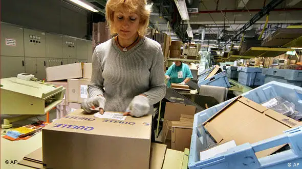 ** FILE ** An employee of German retailer KarstadtQuelle labels a package at the terminal of its mail order branch Quelle in Leipzig, eastern Germany, in this Nov. 23, 2004 file picture. KarstadtQuelle, one of Germany's biggest retailers, said Tuesday, Nov. 28, 2006 that it plans to spin off or sell its Neckermann business as part of a plan to shake up its mail-order operations. KarstadtQuelle said it would concentrate on developing its main Quelle mail-order business, expanding its Internet and teleshopping activities. (AP Photo/Eckehard Schulz)
