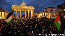 BERLIN, GERMANY - DECEMBER 08: People waving Palestinian and Turkish flags gather in front of the Brandenburg Gate to protest against U.S. President Donald Trump's announcement to recognize Jerusalem as the capital of Israel on December 8, 2017 in Berlin, Germany. Several thousand, mostly Muslim protesters attended the rally. Meanwhile Palestinians are clashing with Islraeli security forces in the West Bank. (Photo by Sean Gallup/Getty Images)