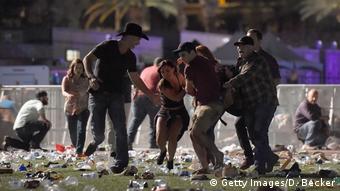 Multiple people flee and try to carry victims in the Las Vegas mass shooting at Mandalay Bay in October 2017