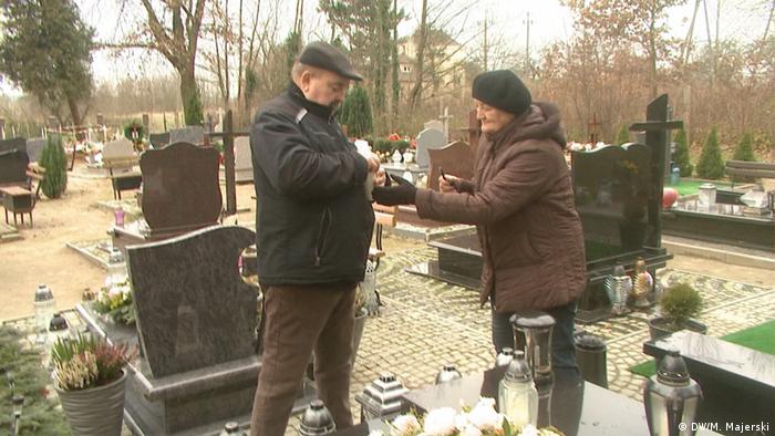 The parents of Lukasz Urban at his grave