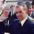 ROMANIA'S LEADER NICOLAE CEAUSESCU WAVES TO THE CROWDS AS HE RECEIVES SOVIET LEADER MIKHAIL GORBACHEV AT BUCHAREST AIRPORT IN MAY 1987. (AP PHOTO)**