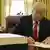 US President Donald Trump signs the tax cut bill into law