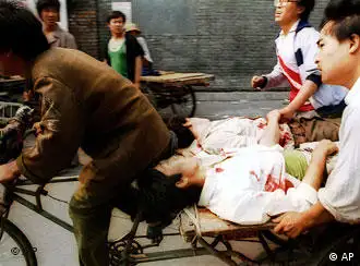 A rickshaw driver fiecely peddles the wounded people, with the help of bystanders, to a nearby hospital Sunday, June 4, 1989. PLA soldiers again fired hundreds of rounds towards angry crowds gathered outside Tiananmen Square at noon. (AP Photo/Liu Heung Shing)