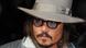 Actor Johnny Depp wearing a grey hat and black-rimmed glasses Actor Johnny Depp wearing a grey hat and black-rimmed glasses
