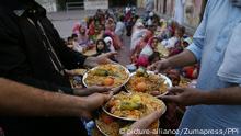 June 1, 2017 - Lahore, Punjab, Pakistan - Pakistani volunteers distributing Iftar foods before breaking their fast on the fifth day of the holy month of Ramzan-ul-mubarak food among the faithful Muslims at historical Wazir Khan Mosque. Muslims around the world celebrate the holy month of Ramzan by praying during the night time and abstaining from eating, drinking, and sexual acts daily between sunrise and sunset. Ramzan is the ninth month in the Islamic calendar and it is believed that the Koran's first verse was revealed during its last 10 nights |