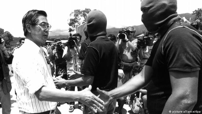 Former President Alberto Fujimoro shakes hands with one of the leaders of Shining Path