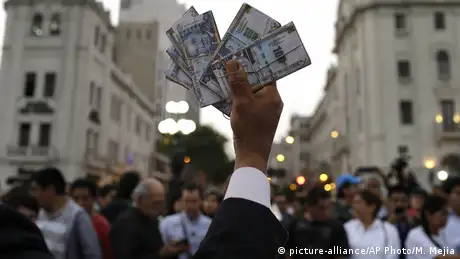 A protester holds up fake money during an anti-corruption march in Lima, Peru, in December 2017
