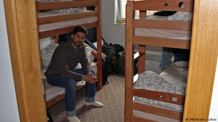 Nasib Khan sits in a small room filled with bunk beds