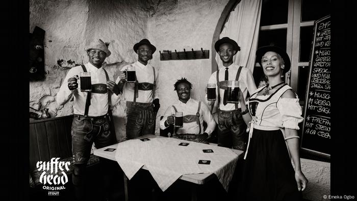 Emeka Ogboh photograph in which five people of color are seen in traditional Bavarian clothes holding beer mugs