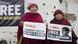 Two exiled Tibetan nuns hold placards demanding the release of Tashi Wangchuk Two exiled Tibetan nuns hold placards demanding the release of Tashi Wangchuk