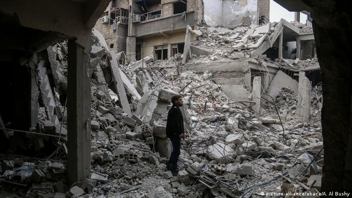 Wreckages of collapsed buildings are seen after airstrikes in the besieged town of Arbin in Eastern Ghouta, Syria