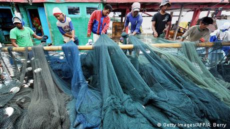 Fishermen tend to their nets