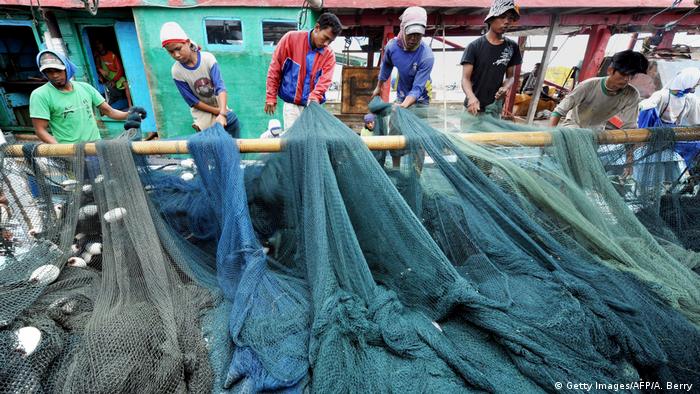 Fishermen tend to their nets