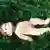 Doll lying in the grass