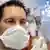 Man with mask fills medication into syringe