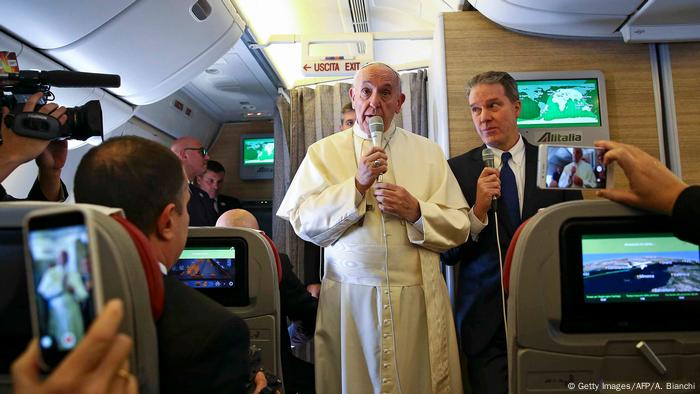 Pope Francis talks to journalists.