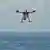 Shark-spotting drone flying above water north of Sydney