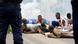 Protesters lie on the road amid tear gas. Protesters lie on the road amid tear gas.