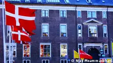 Denmark, Copenhagen, brick building with Danish flags (Niaz Moammadkhani)