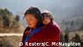 A woman carries her daughter near Punakha, Bhutan, December 14, 2017. REUTERS/Cathal McNaughton SEARCH BHUTAN FOR THIS STORY. SEARCH WIDER IMAGE FOR ALL STORIES. TPX IMAGES OF THE DAY