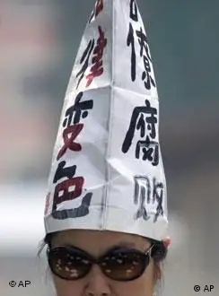 A Chinese petitioner wears a hat with the words Officials Corrupt, Changed Judiciary in Beijing, China, Monday, May 4 , 2009. Protesters timing their protest on the 90th anniversary of May Fourth protest movement strung banners from a Beijing hotel and flung handbills off the roof seeking redress for a litany of grievances and in hopes of winning attention from authorities to their plight. (AP Photo/Ng Han Guan)