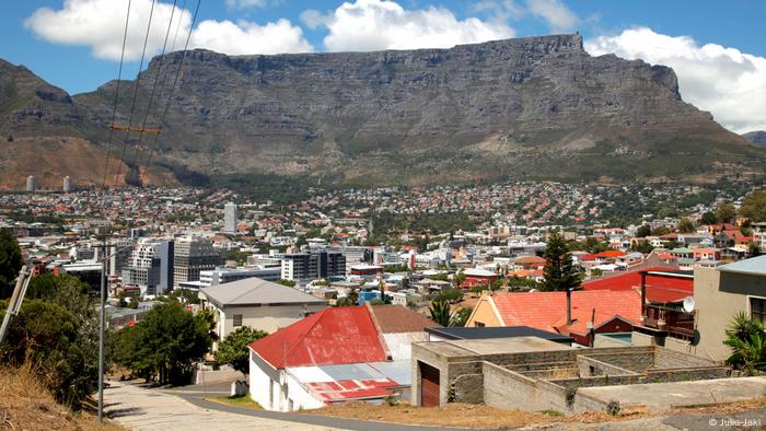 Table mountain looms behind buildings and dwellings