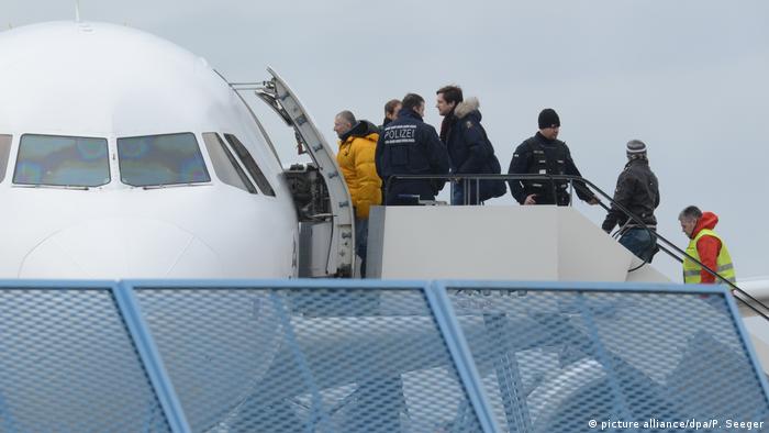 An archive picture showing rejected asylum seekers boarding an aircraft